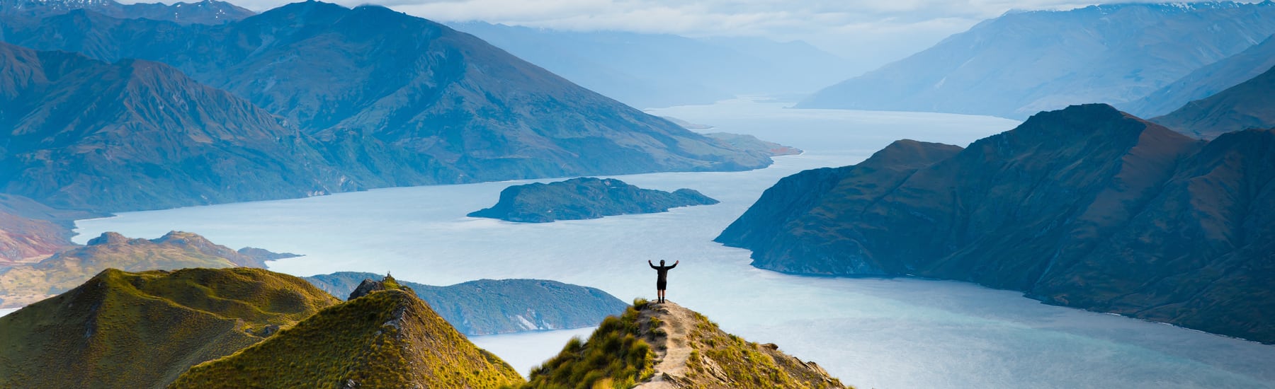 Hiker overlooking a mountain lake in New Zealand